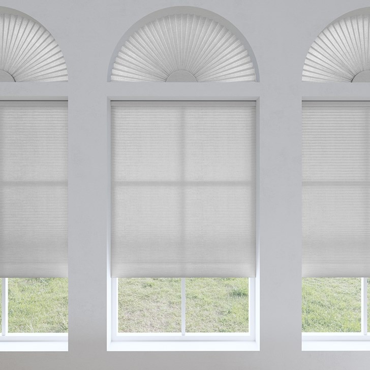 Light Filtering Arch and Light Filtering Cellular Shades in the Gray Sheen color.